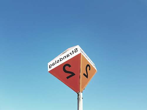 road sign worm's eye view of Strandslag 2 signage street sign